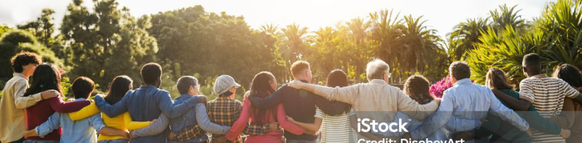 A man hugs his father while standing in a modern living room.